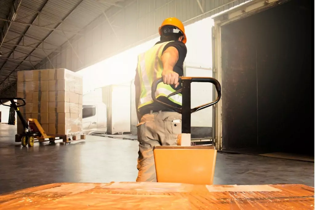 warehouse worker unloading pallet shipment goods into a truck picture id1195392846